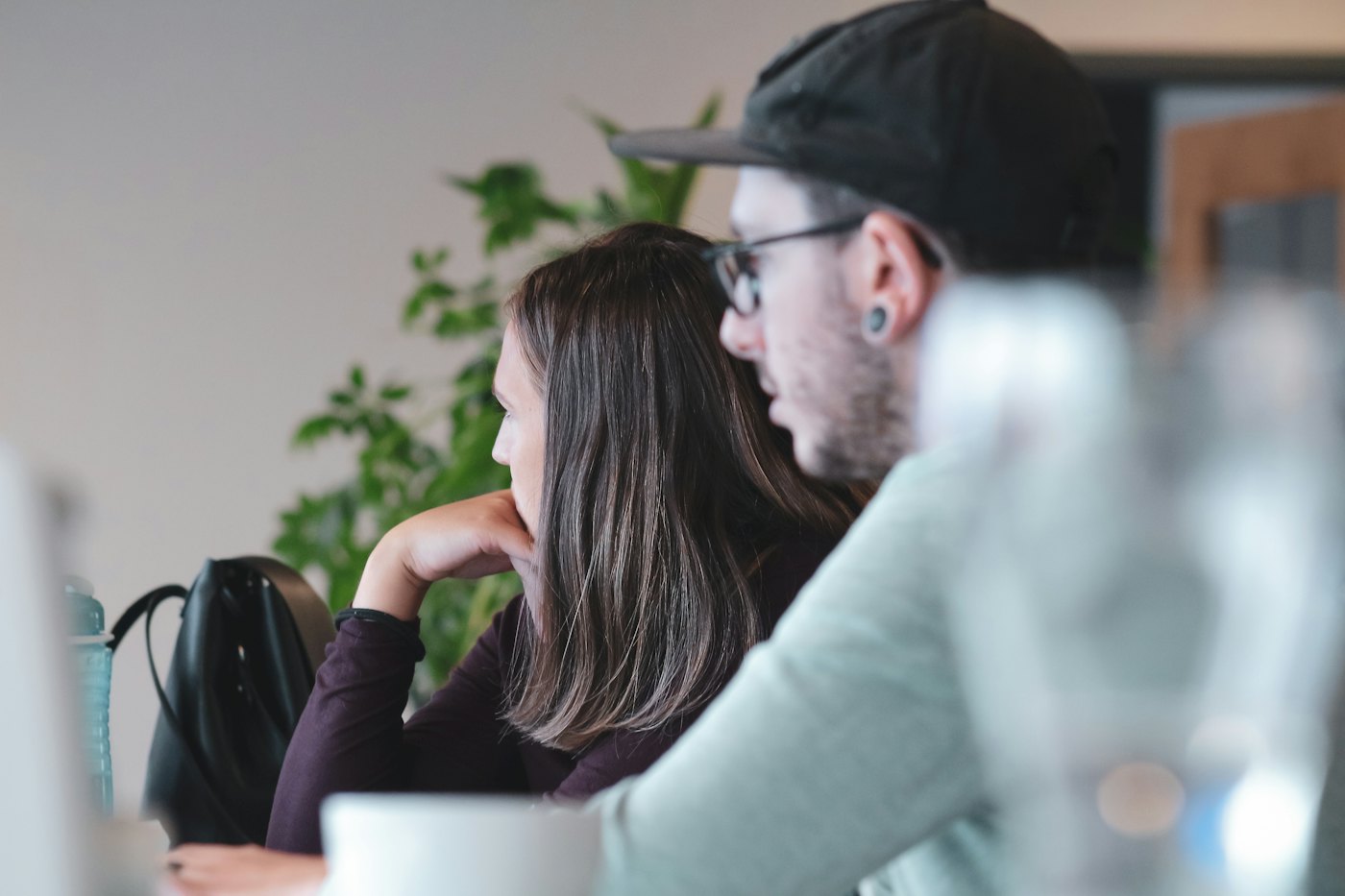 Editors reviewing article clips on a monitor