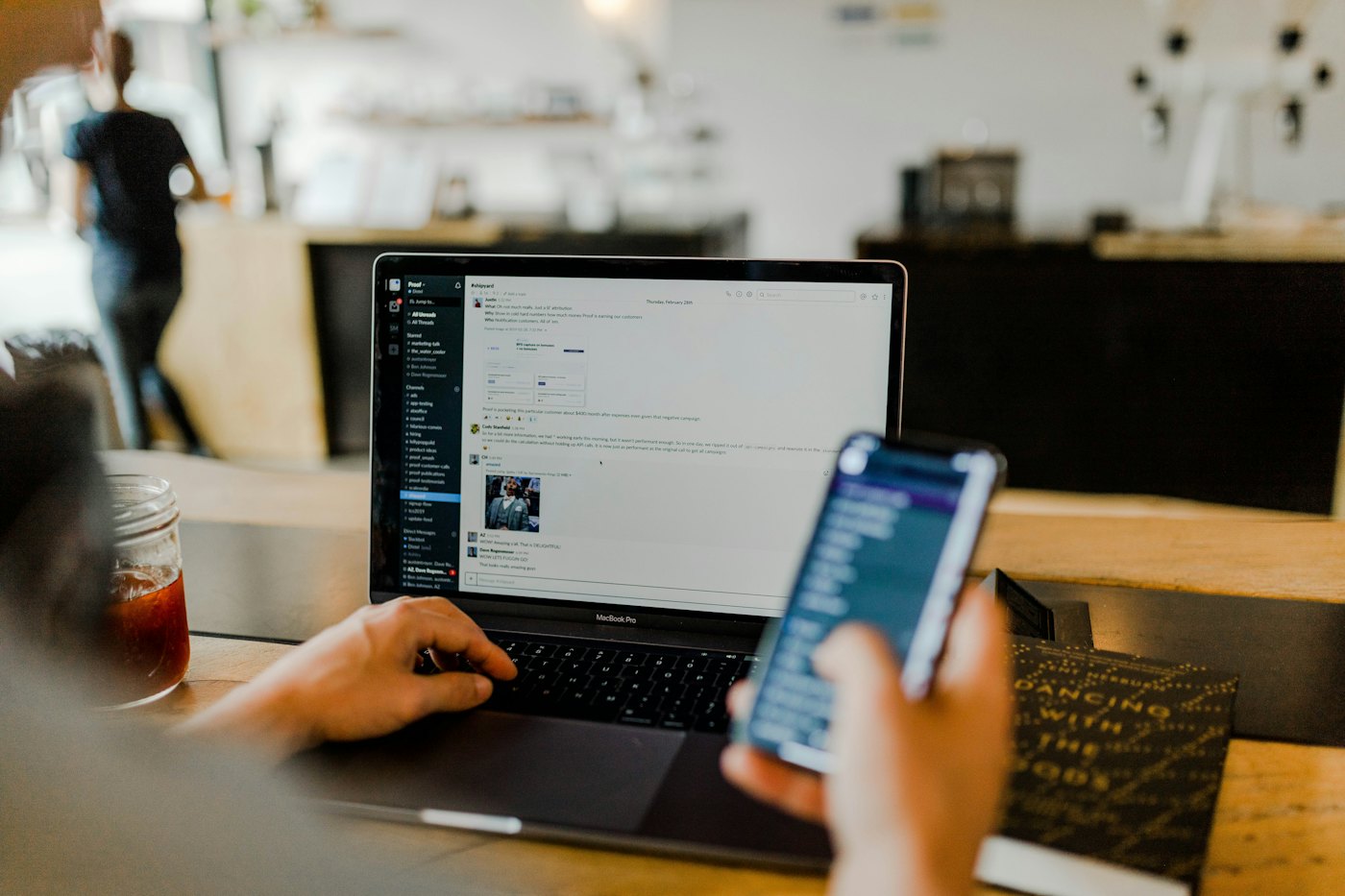 Person comparing a digital newspaper reading experience on phone and laptop