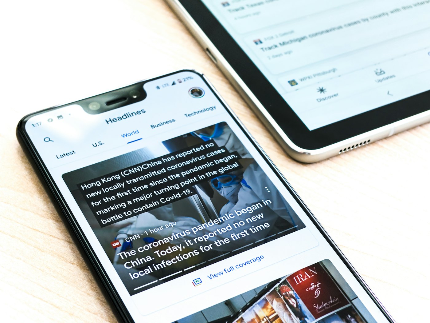 News displayed cleanly on a smartphone compared to a hard-to-read PDF page